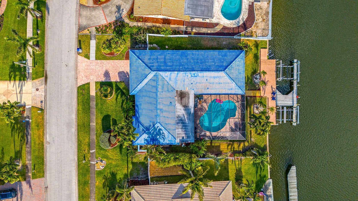 Cocoa Isles House | Luxury Canalfront Home w/Heated Pool, Game Room, Boat & Jet Ski Lifts
