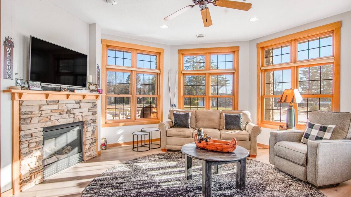 Three Lakes Condo | Modern lakefront condo with grill, W/D, gas fireplace, indoor pool, & hot tubs