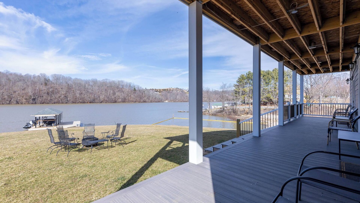 Ingles House | Modern lakefront home with wraparound decks, firepit, and stunning water views on both levels.