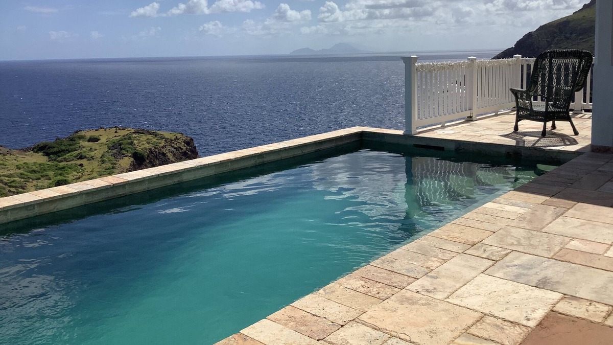 Windward Side Villa | Modern Luxury Villa in Flatlands. Pool. Walk to Beach. Sleeps 6. Ocean Views.
