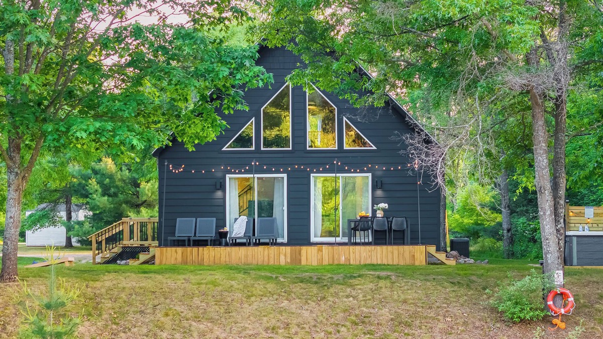 Evart Ski Chalet | Modern Riverfront Chalet w/Firepit & Hot Tub