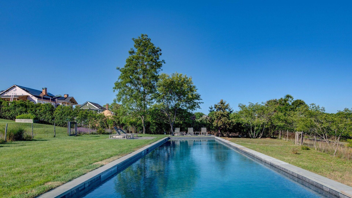 Eastport House | Modern-style home with a private pool, vast back lawn, several sitting...