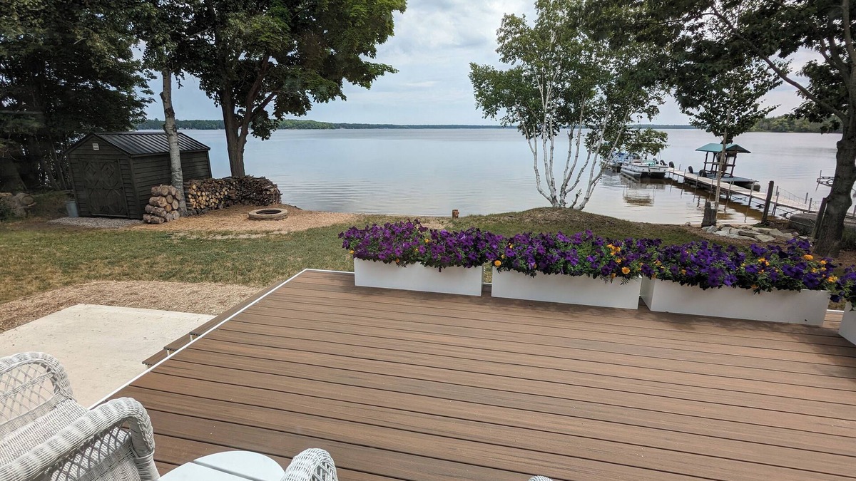Carp Lake Cottage | NEW! Renovated lakeside cottage with a private sandy beach. Great Location!