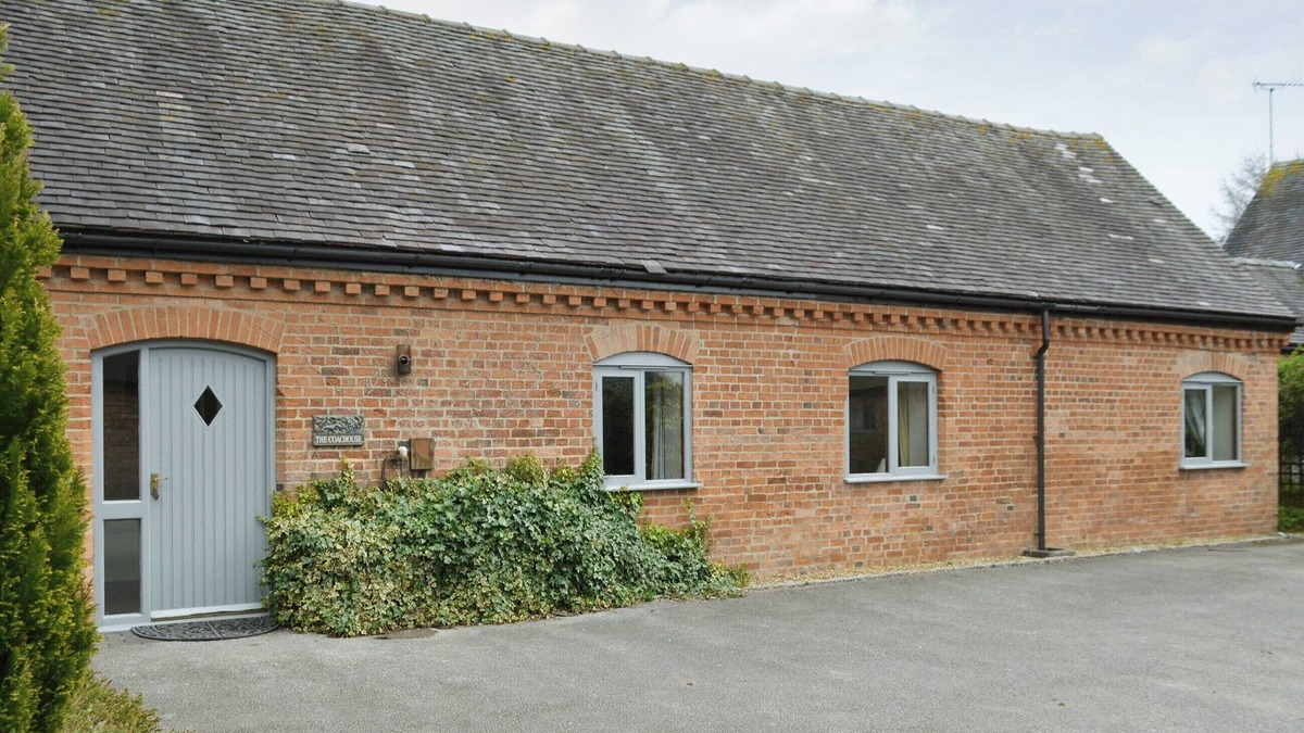Denstone Cottage | One of two barn conversions with exposed beams and trusses.