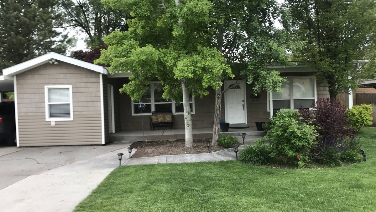 Millcreek House | Open floor plan with a covered patio and fenced yard.