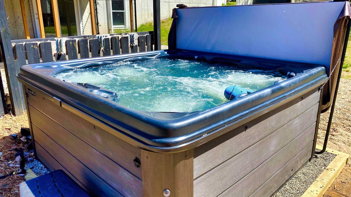 Grawn House | Pet-friendly home with fenced-in yard and hot tub