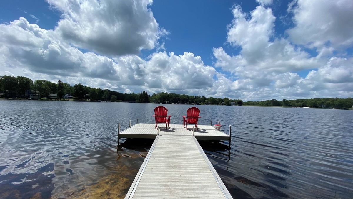 Penn Lake Park House | Pocono Lakefront Home- with Private Dock & Swim Raft, Fire Pit, & Boats!