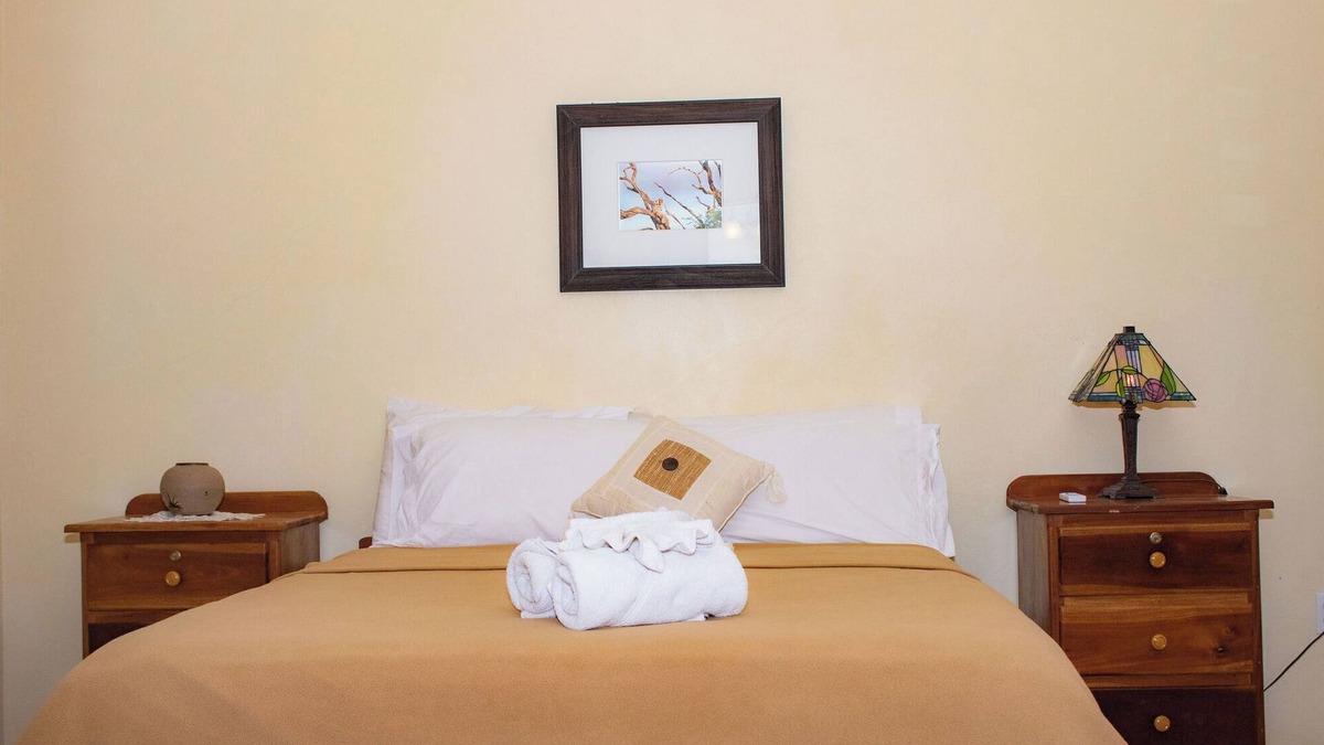 Orchid Bay Bed & Breakfast | Queen-size bed, with a private bathroom, a walk-in shower and closet.