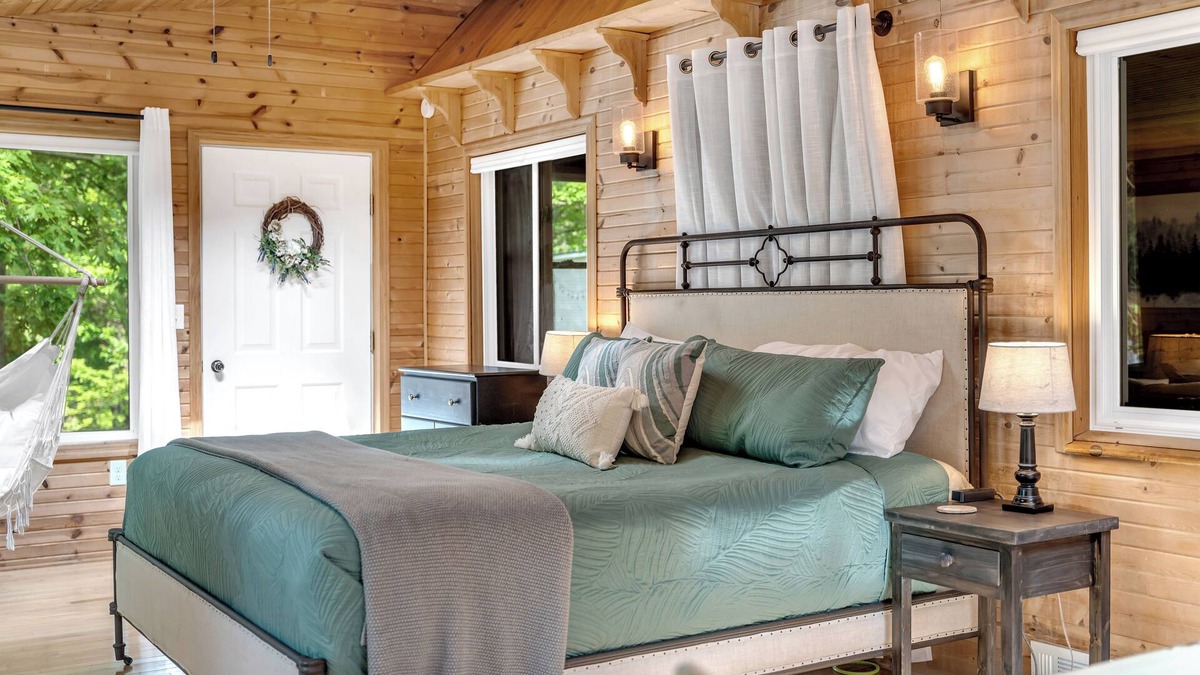 Evart Cottage | Quiet, private and wooded waterfront on a huge lot. King beds. Boats included!