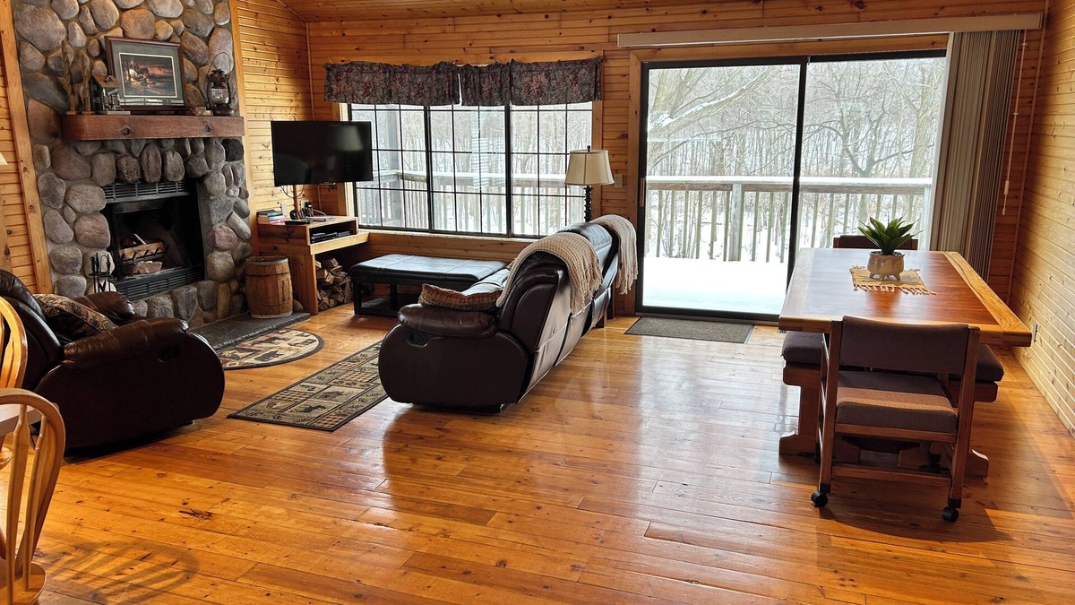 South Haven Cottage | Riverbend Retreat Middle Branch CottagenFireplace and hot tub with river view.