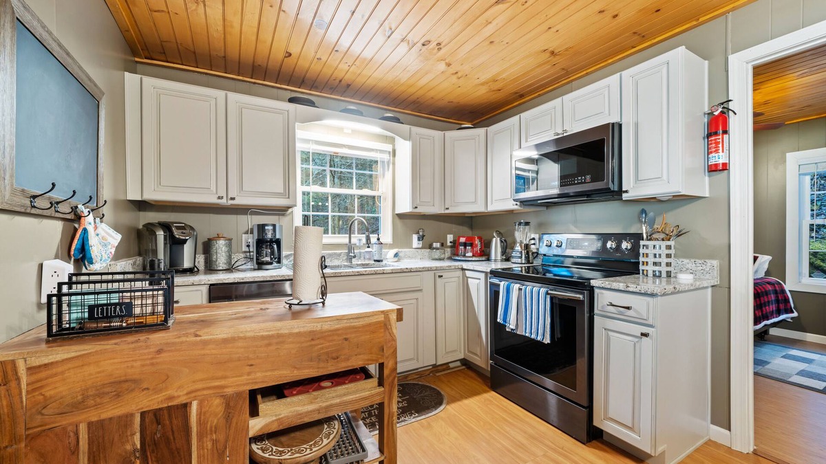 Cherry Log House | Riverfront oasis with hot tub, firepit, game room, & trail access - dog-friendly