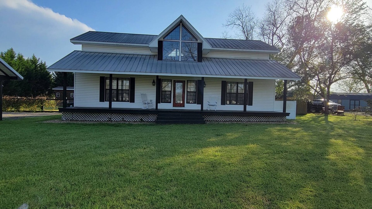 Peach County House | Rocking Chair front porch looking out on sprawling pecan trees filled w/nature.