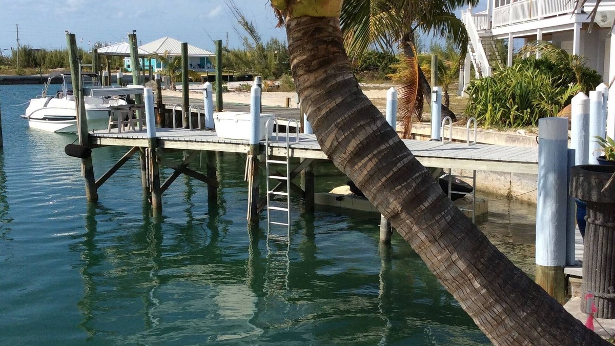 Treasure Cay Villa | Romantic cozy boathouse on the water surrounded by tropical gardens