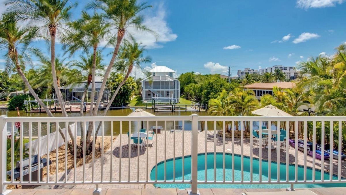 South Island House | Sand Dollar #3 - Upstairs Apt with Shared Pool on Canal by the Beach!