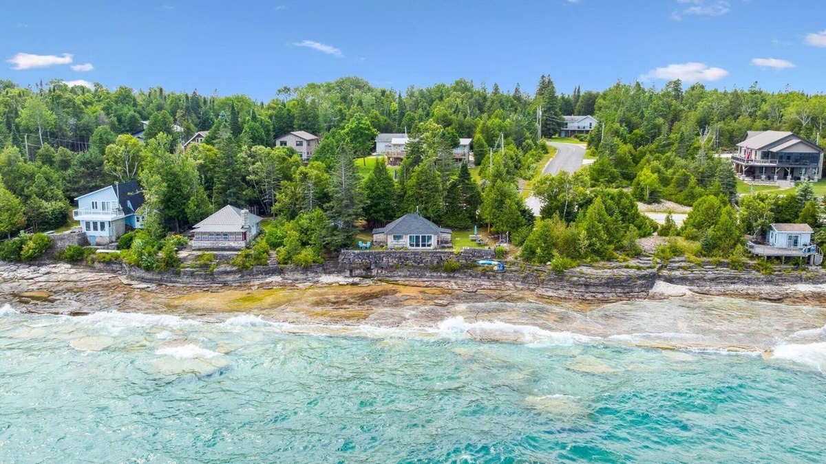 Lion's Head House | Seafari is a charming stone cottage on Georgian Bay with stunning bluff views, a flat rock shoreline, and a cozy bunkie. Perfect for relaxing, swimming, and exploring.