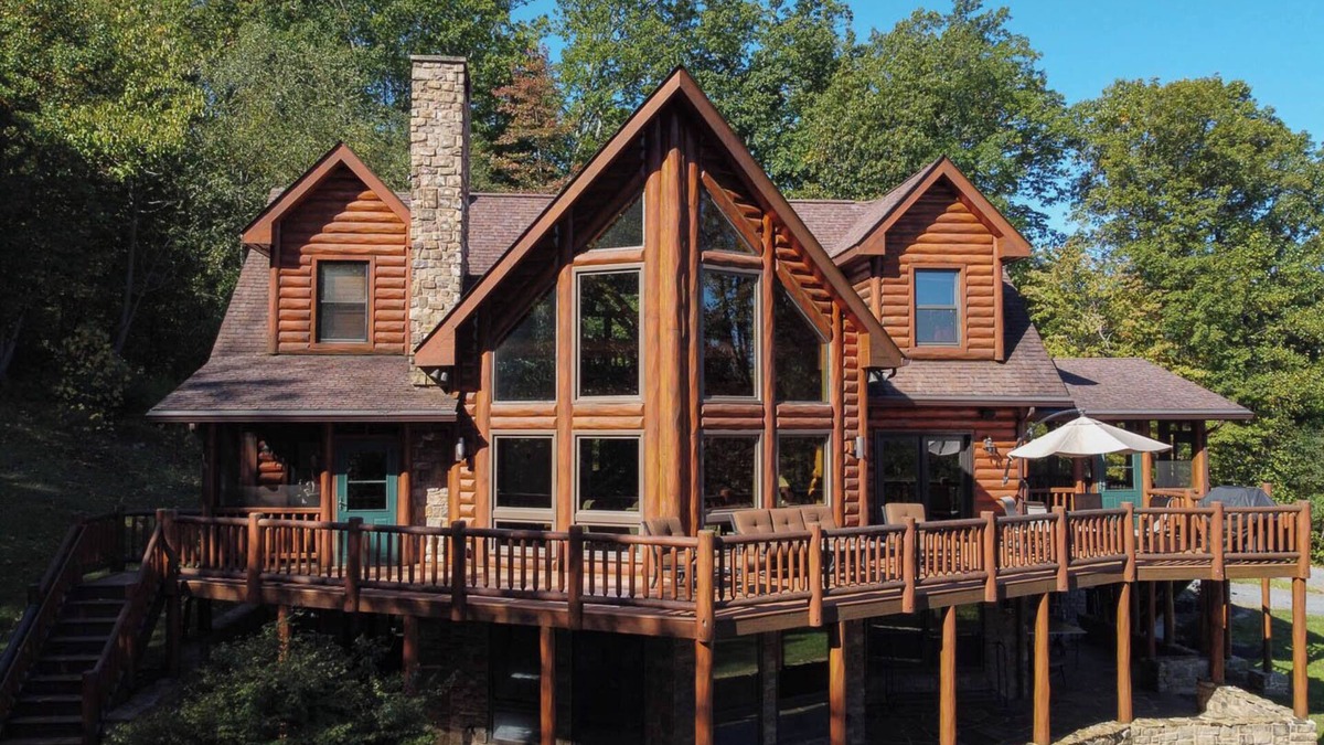 Huntly House | Secluded 4 bedroom log style home with screened porches, deck and fishing pond.