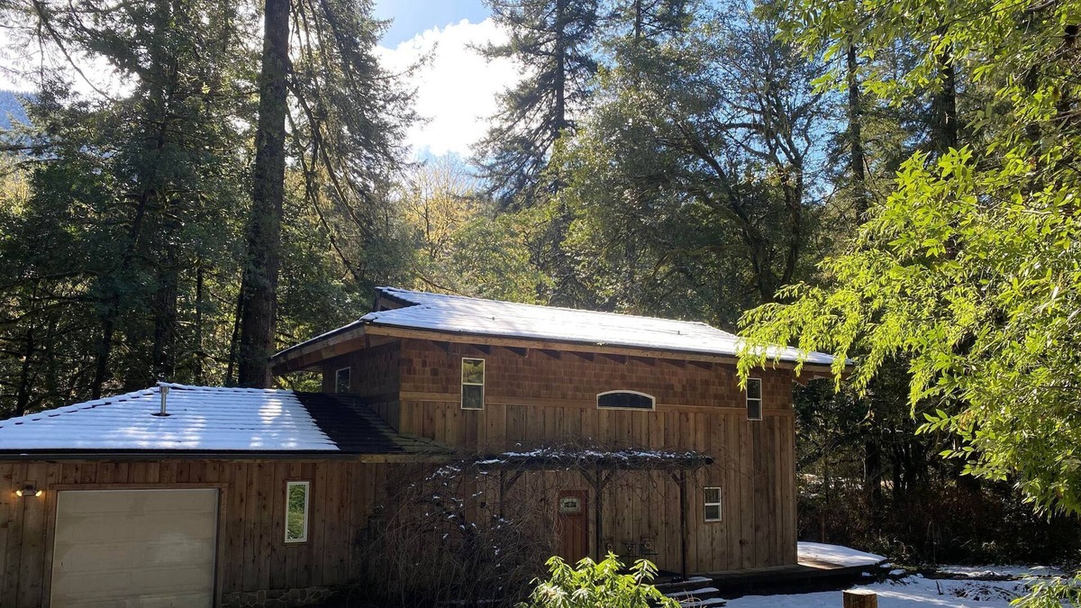 Coos Bay House | Serene Creekfront Lodge style home hidden away in Elliot National Forest