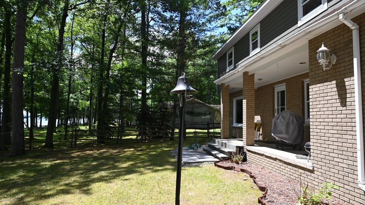 Hubbard Lake House | Spacious vacation home on large private wooded lot on crystal clear Hubbard Lake