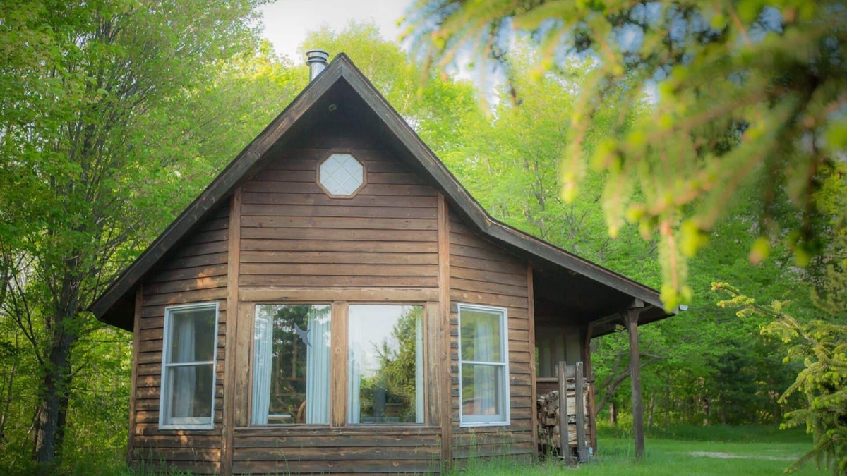 Finlayson Cabin | Spiral Staircase Leads To The Lofted Bedroom With Wall To Wall Knotty Pine.