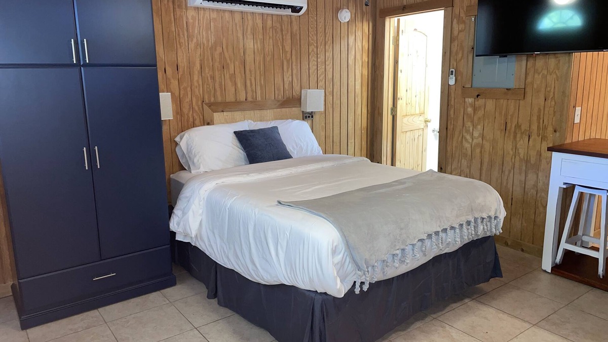Porum Cabin | Studio cabin #3 with lake view and boat dock access, outdoor seating.