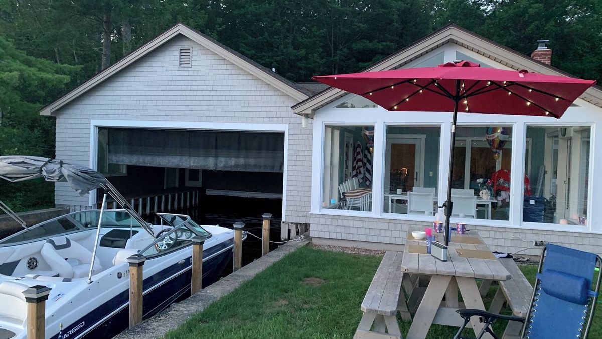 Sanbornville House | Stunning lakefront home with a boathouse, private dock, firepit and lake views