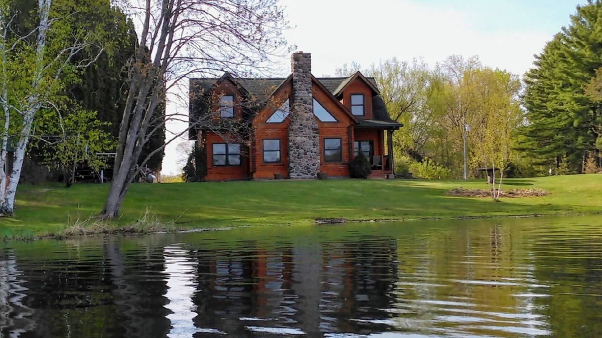 Grantsburg Cabin | Stunning log home with a rental pontoon on a quiet sunlit bay. Check it out!