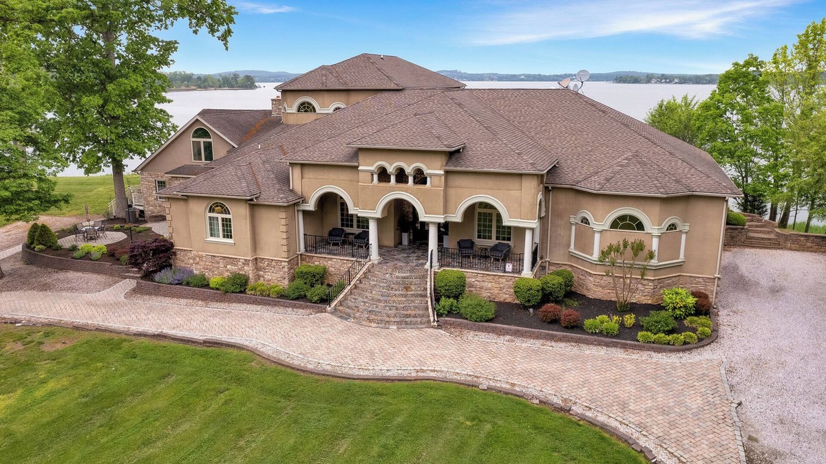 Earlville Villa | Stunning waterfront villa with indoor pool and kids swing set and play area.