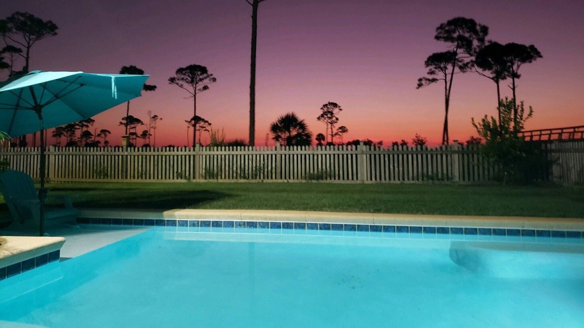 Port St. Joe House | Summer Bay, a beautiful Bay View Home private backyard oasis around the swimming pool, screened porch, and sundeck