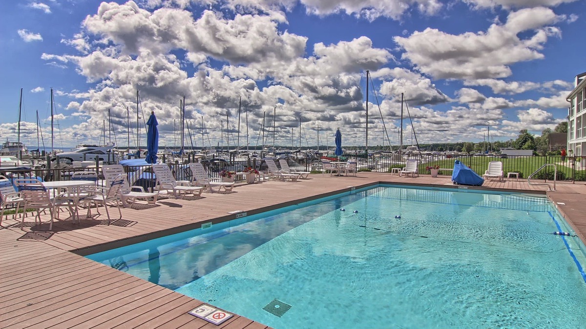 Charlevoix Condo | Summer Pool Access | Short walk to Ferry Beach | Directly on Lake Charlevoix