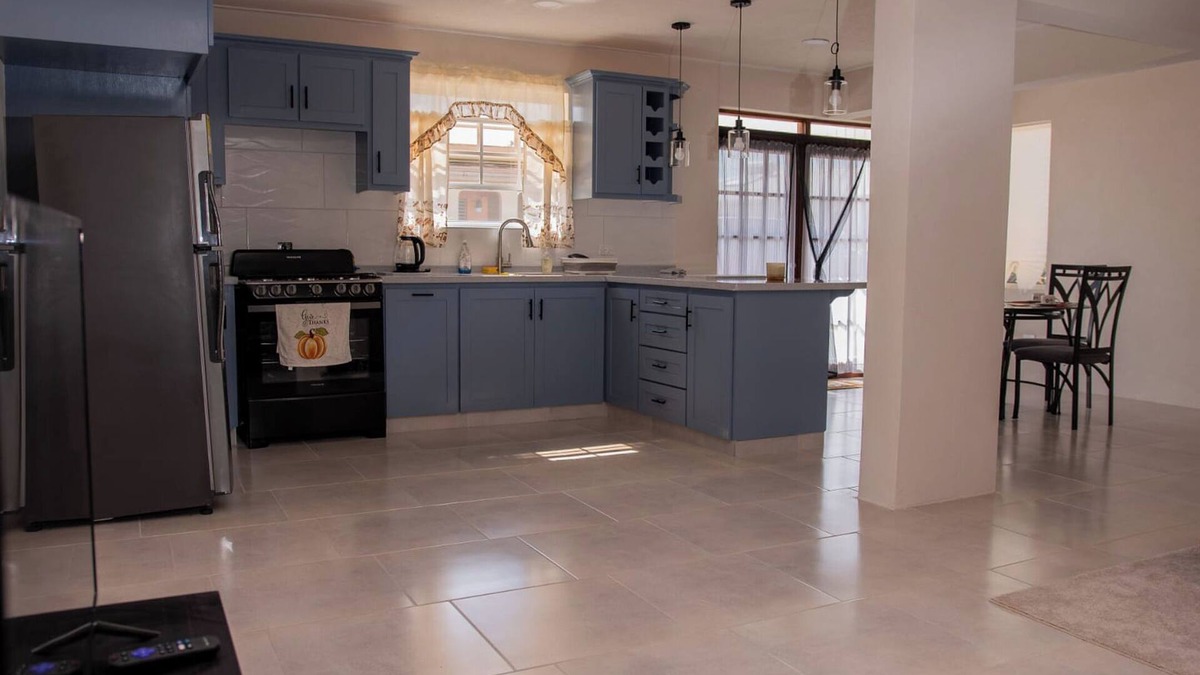 Ragged Point Apartment | The apartment features an open plan living and dining area, and a spacious and modern kitchen.