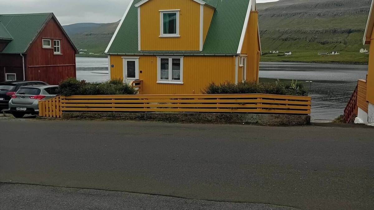 Trongisvagur Villa | The Little Yellow House Cozy Old Faroese wooden house.