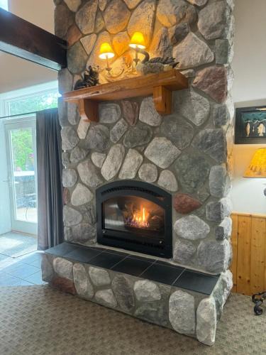 Squaw Lake Resort | The River Condos Hot Tub Fireplace Family & Pet Friendly River Front 2 to 6 bedroom condos dock