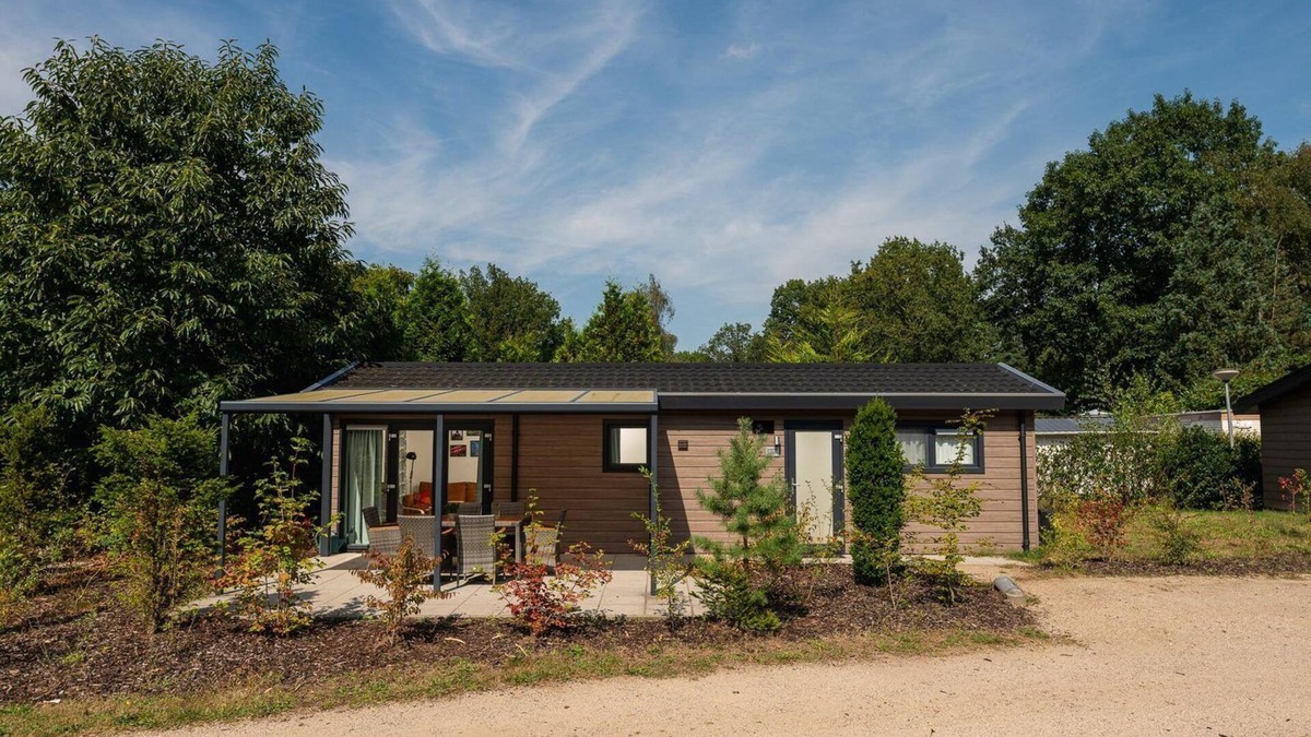 Lieren House | The Veluwe Lodge offers luxury and space for 5 guests with modern amenities in a serene, green setting.