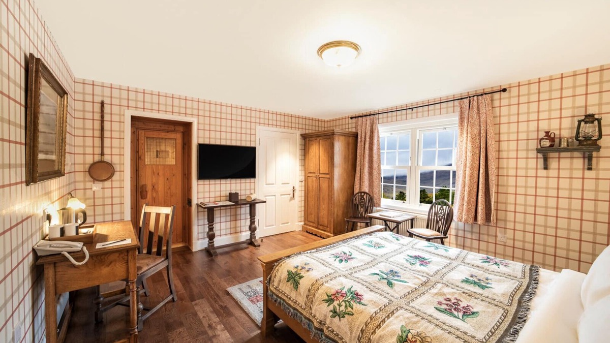 Shiel Bridge Bed & Breakfast | The wooden floors, vintage furniture, and tartan accents create a comfy room