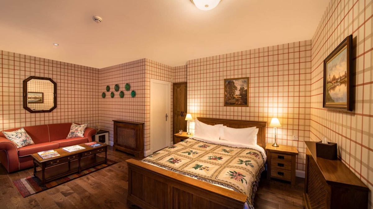Shiel Bridge Bed & Breakfast | The wooden floors, vintage furniture, and tartan accents create a comfy room
