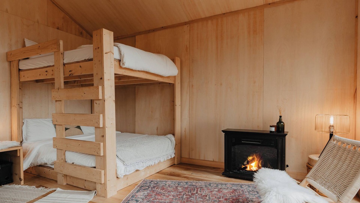 Liberty Cabin | Tiny cabin amongst trees on a farm with alpacas