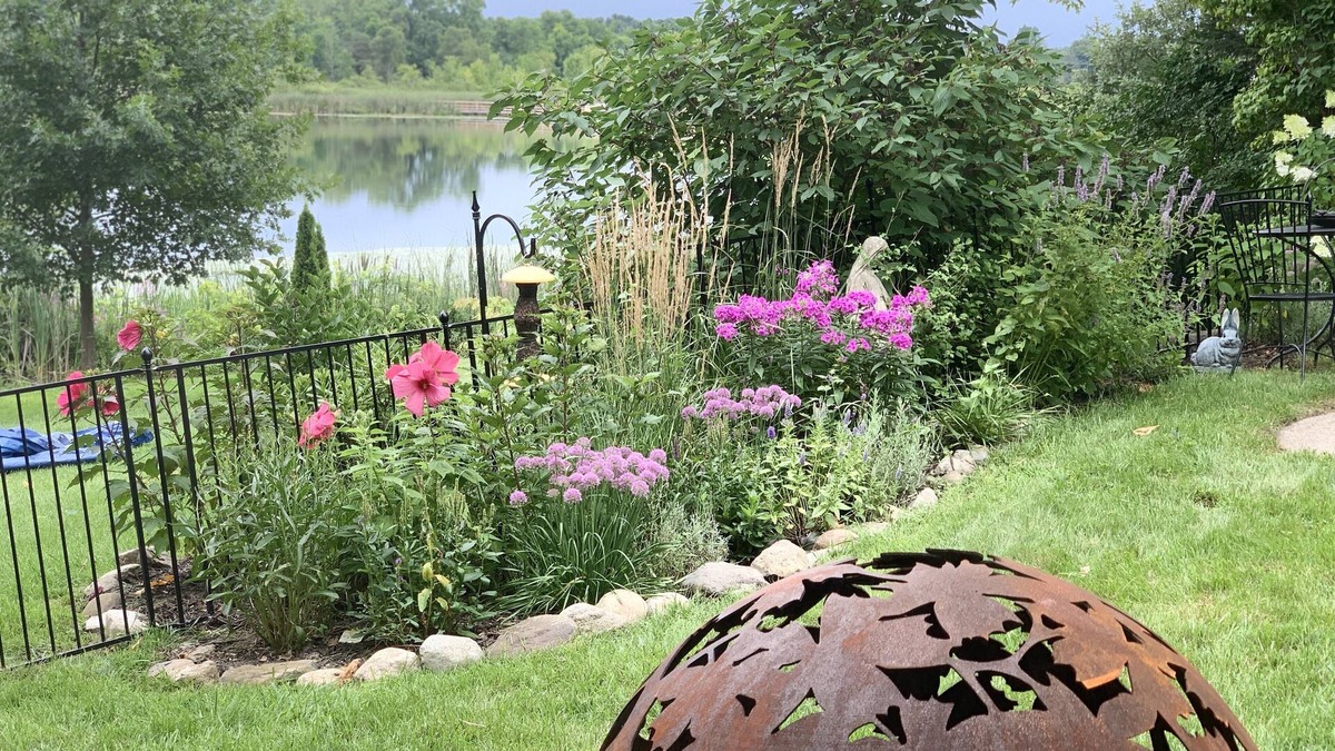 Howell House | Tranquil haven with a roomy deck and stunning panoramic lake views.