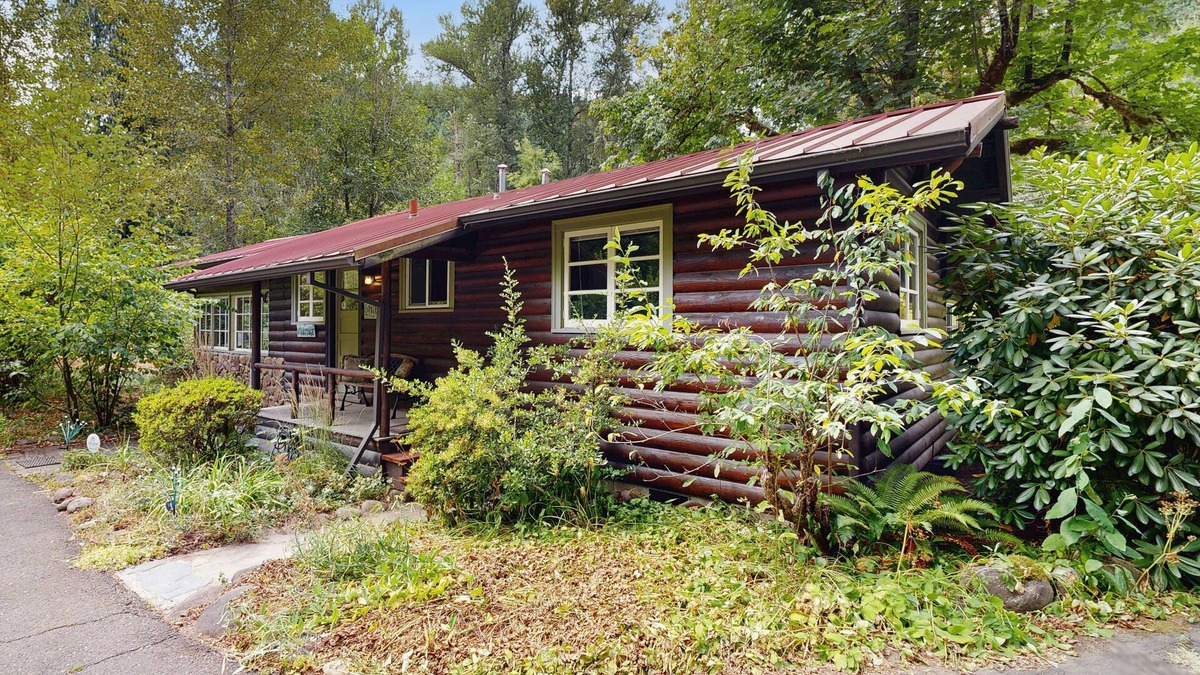 Molalla Cottage | Tranquil landscape with riverside firepit, gas grill, gas fireplace, and deck