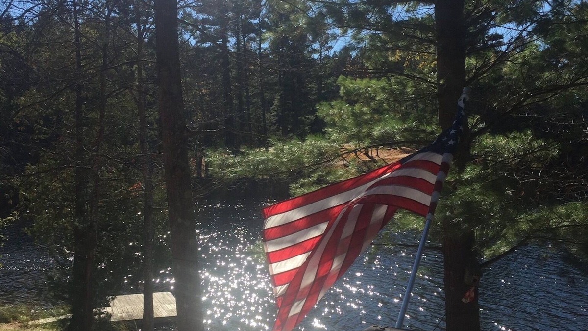 South Boardman Cottage | Traverse City area Lakefront Log Home, FREE Hot Tub, WIFI, & Boats.