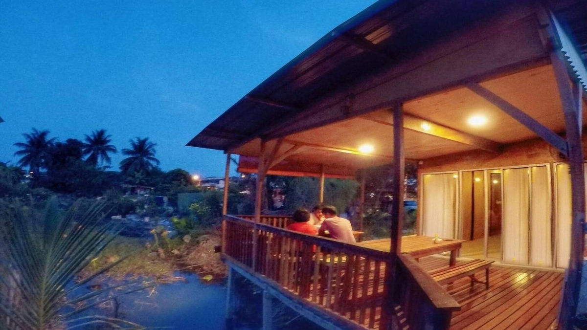 Ipoh House | Tung's Tropika - with a wooden hut by a lake
