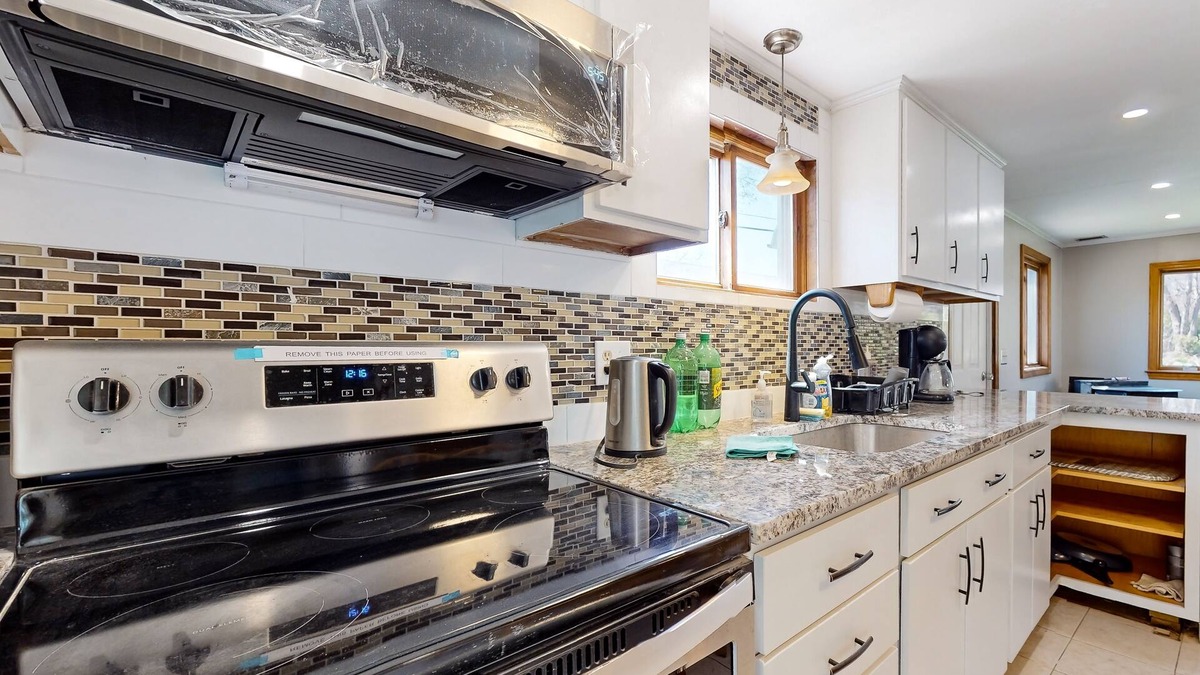 Sandown House | Two-story dog-friendly home with a lake view, deck, gas grill