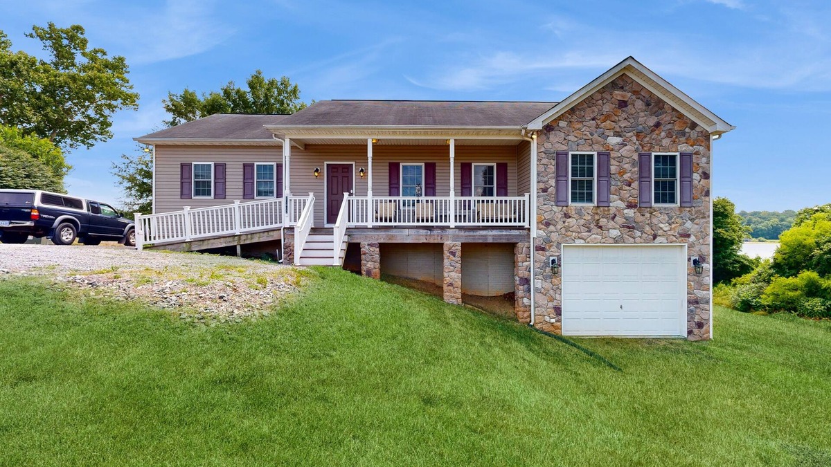 Orange House | Two-story, lakefront getaway with dock, beach, grill, 2 kayaks, 2 canoes, AC