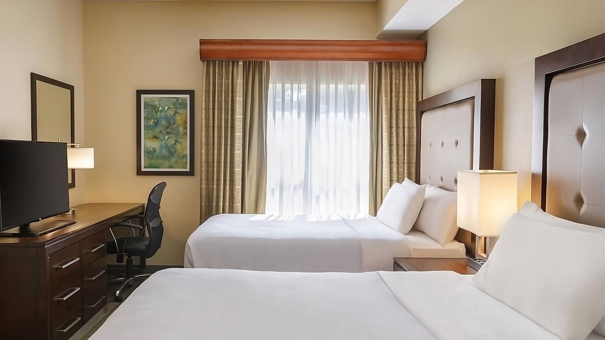 Feather Sound Hotel | Unwind and Indulge In Our Oasis! Outdoor Pool, Free Breakfast, Full Kitchen!