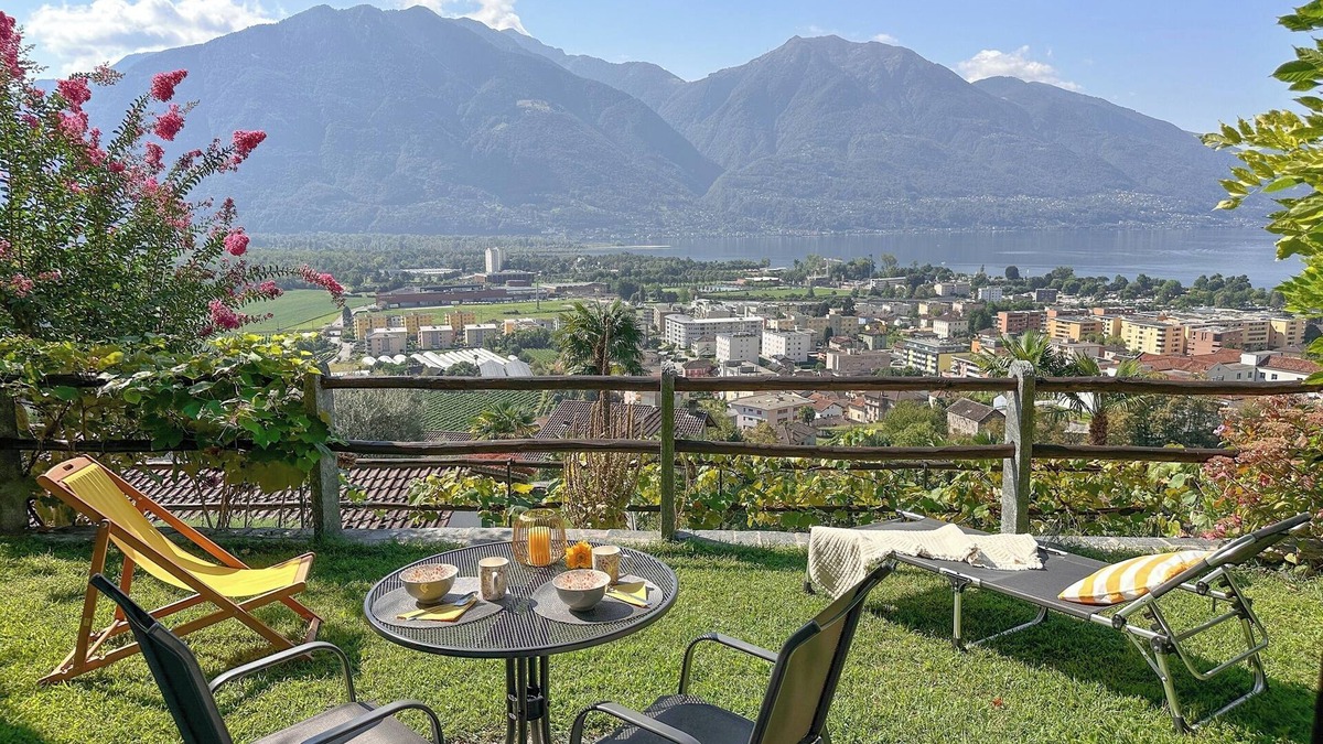Gordola Apartment | Vacation apartment with panoramic view and outdoor pool, garden seating area and sunbathing lawn