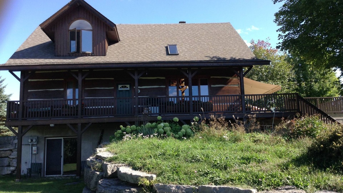 North Algona Wilberforce Cottage | Waterfront log home on Lake Dore. Decks, dock, outdoor hot tub and fire pit.