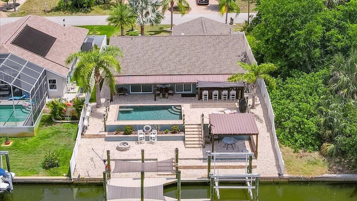 Palm Harbor House | Waterfront Retreat with Pool, Tiki Bar & Boat Dock