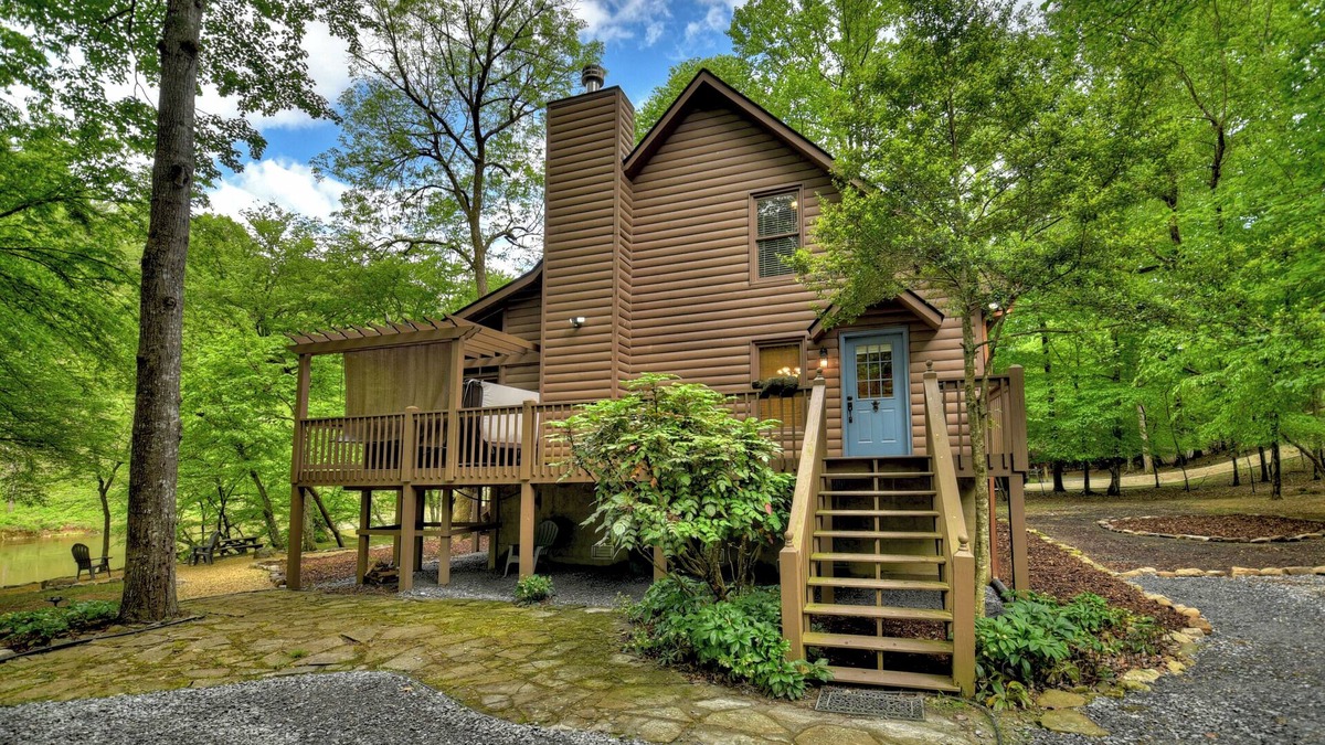 Ellijay Cabin | Welcome to Relaxing River Retreat, where your pets are welcome amidst a scenic riverfront, screened porch, hot tub, WiFi, firepit, and abundant wildlife