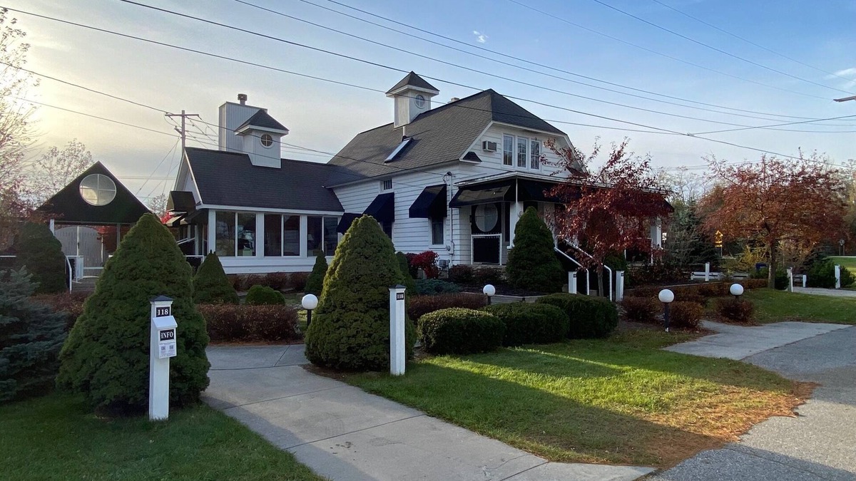 Suttons Bay House | White Fence Main House on Suttons Bay Waterfront!