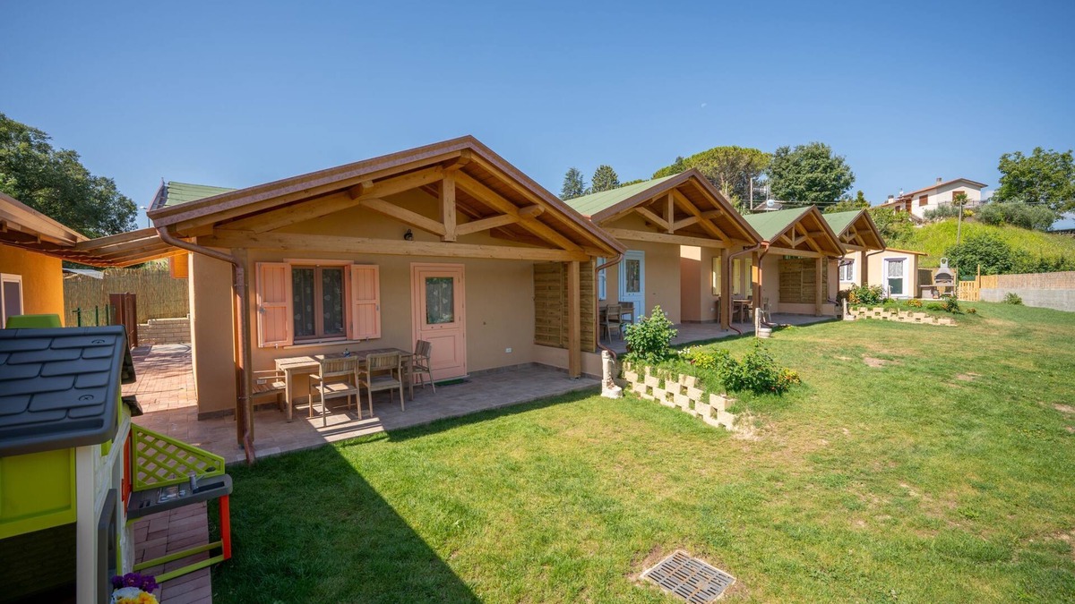 San Brizio Apartment | Wooden house with porch and garden