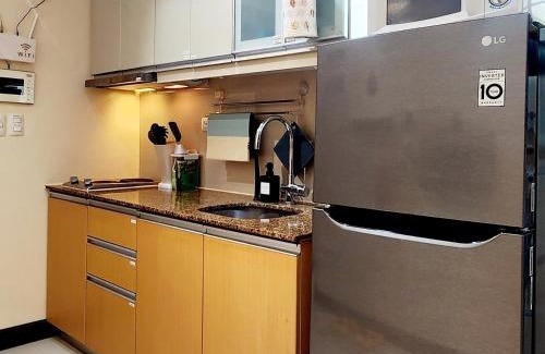 Pinagsama Apartment | 14e BGC Cozy Vibrant unit minutes Walk to Grand Canal Mall with Paid Parking on Premise Pet friendly with Pool and Gym